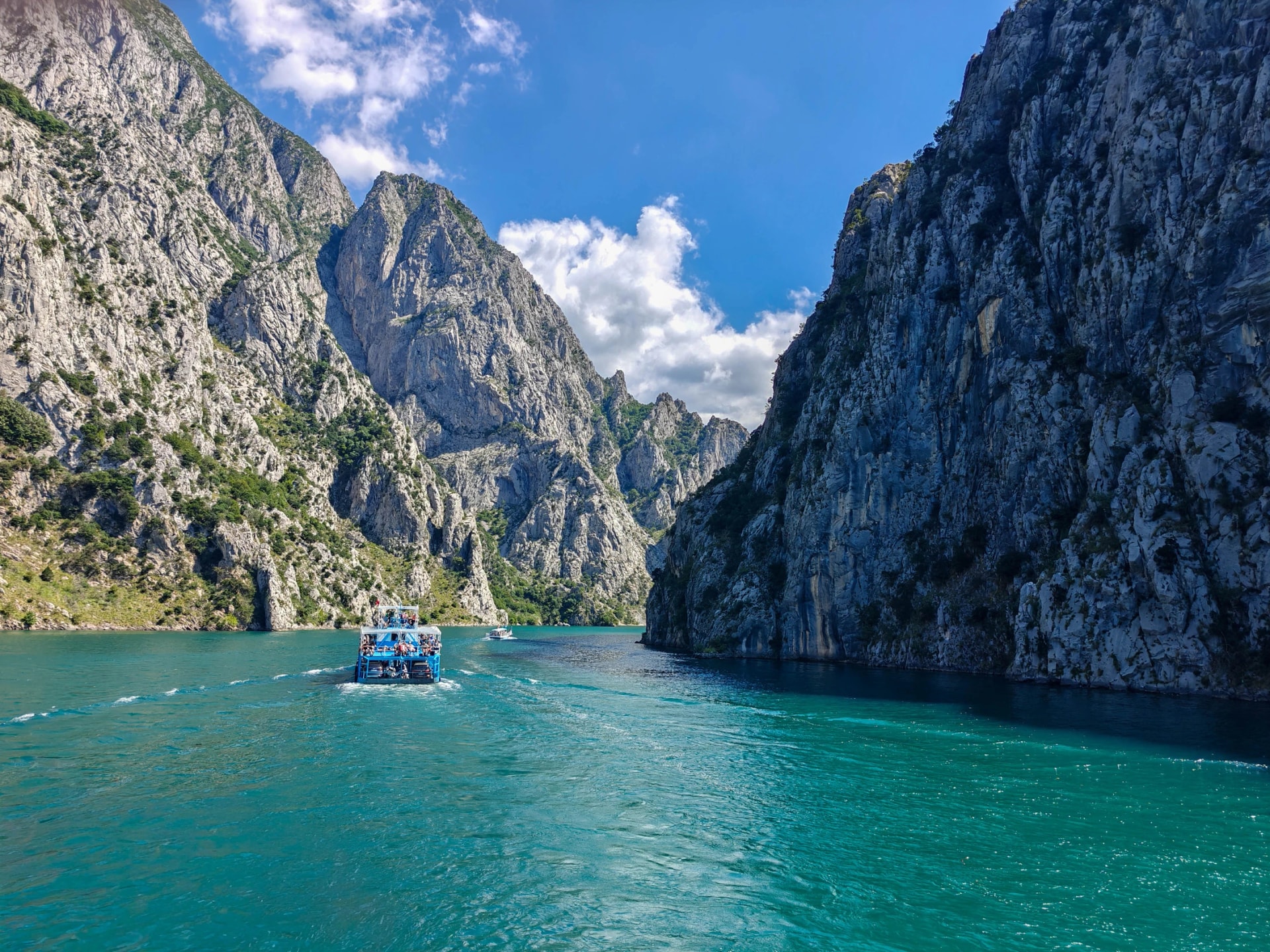 Ferry boat entering narrow canyon of Lake Koman