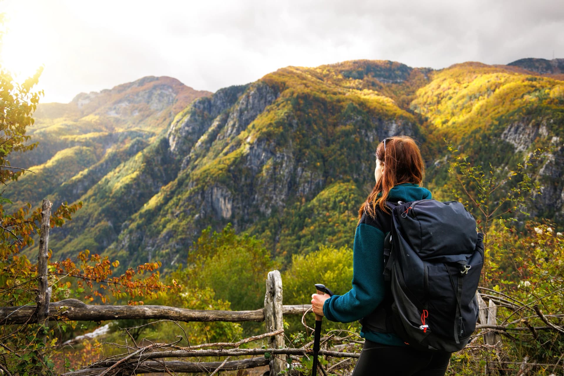 Woman Hiking in the Albanian Alps Looking at a Mountain in Beautiful Autumn Colors
