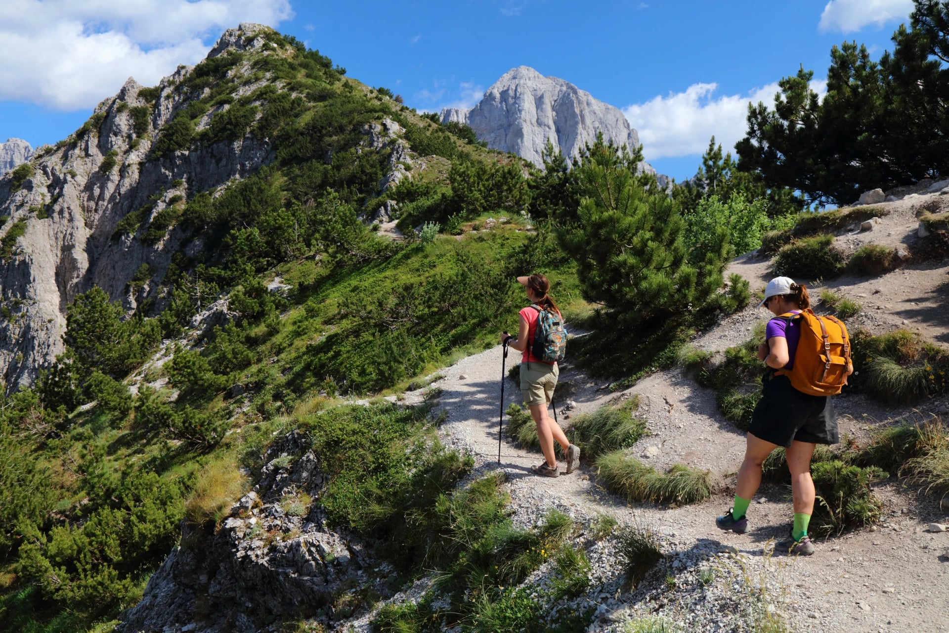 Hikers on a rocky trail above Theth