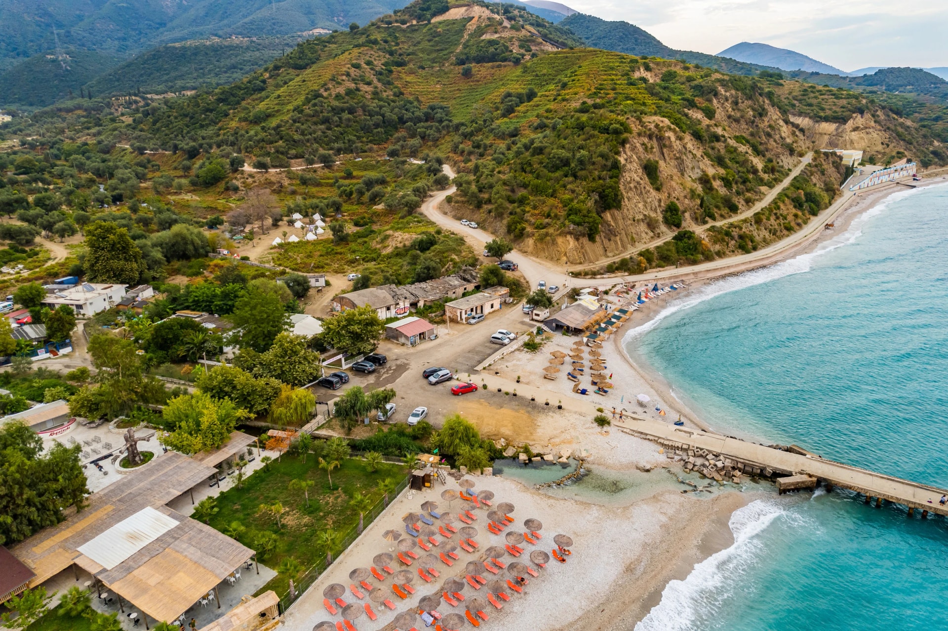 Aerial view of Bunec Beach area with concrete pier in Summer 2022, Albania